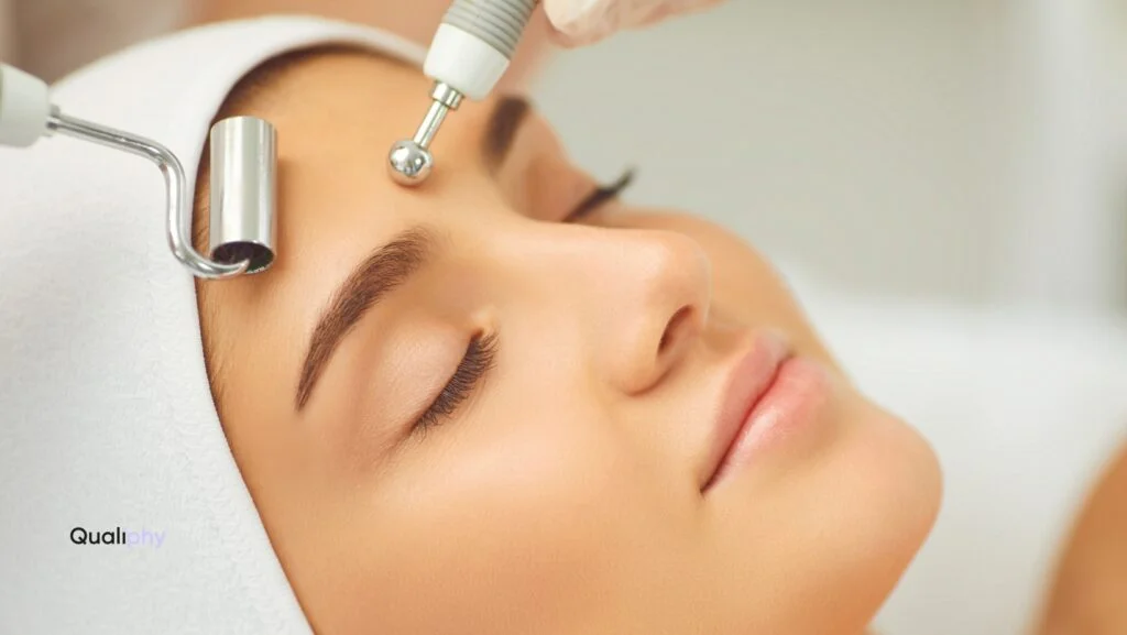A woman with flawless skin relaxes during a med-spa facial treatment using advanced tools; image represents the professionalism and care associated with services that require Good Faith Exams before aesthetic procedures.