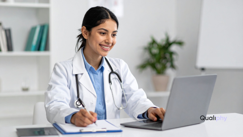 A female clinician smiling while conducting an on-demand telemedicine consultation on her laptop, representing modern virtual healthcare services available across the U.S.