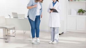 Doctor consulting with a female patient during a medical weight loss appointment, highlighting compliance risks for weight loss clinics and GLP-1 treatment programs.