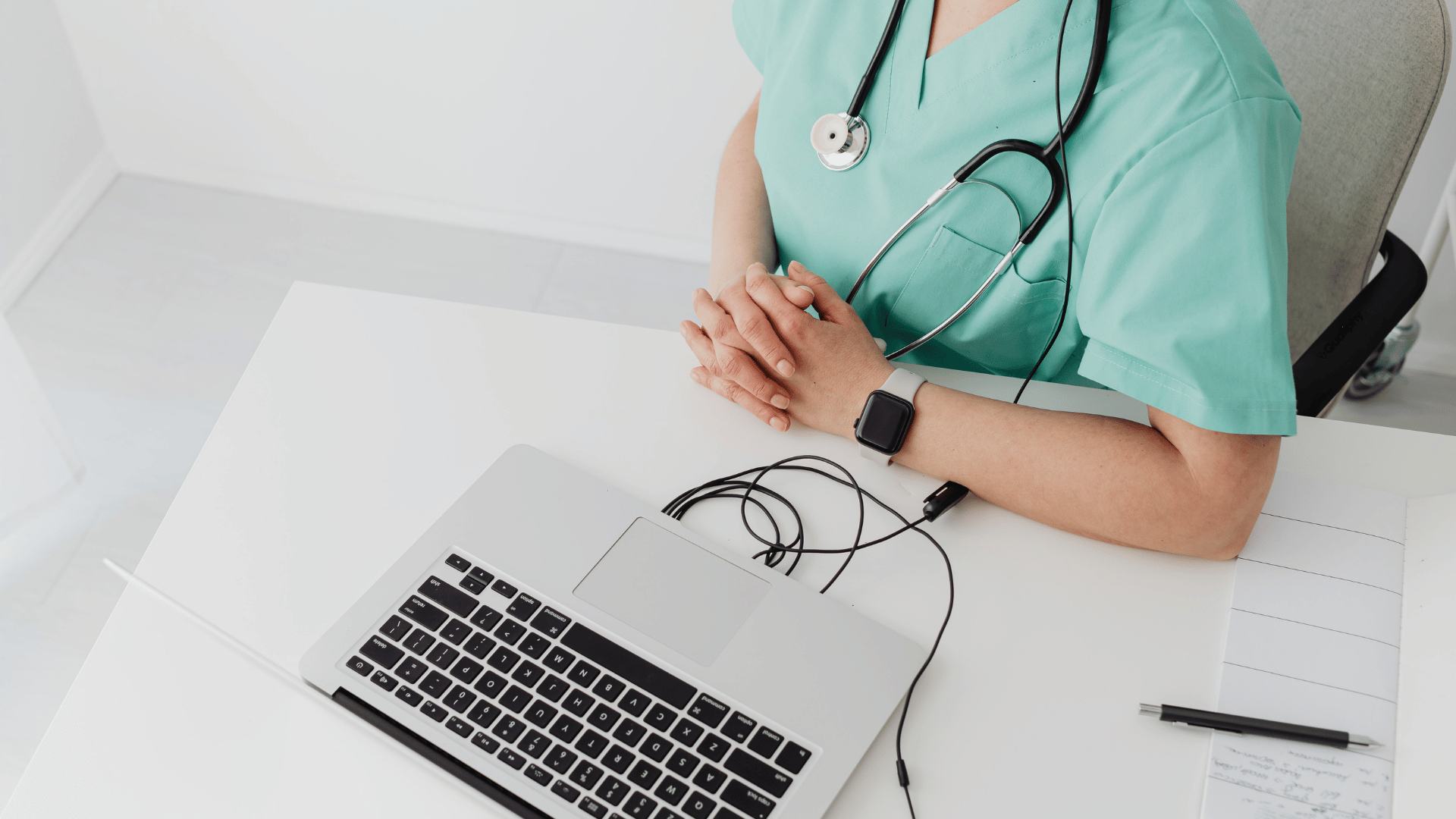 Provider completing a good faith exam on a laptop